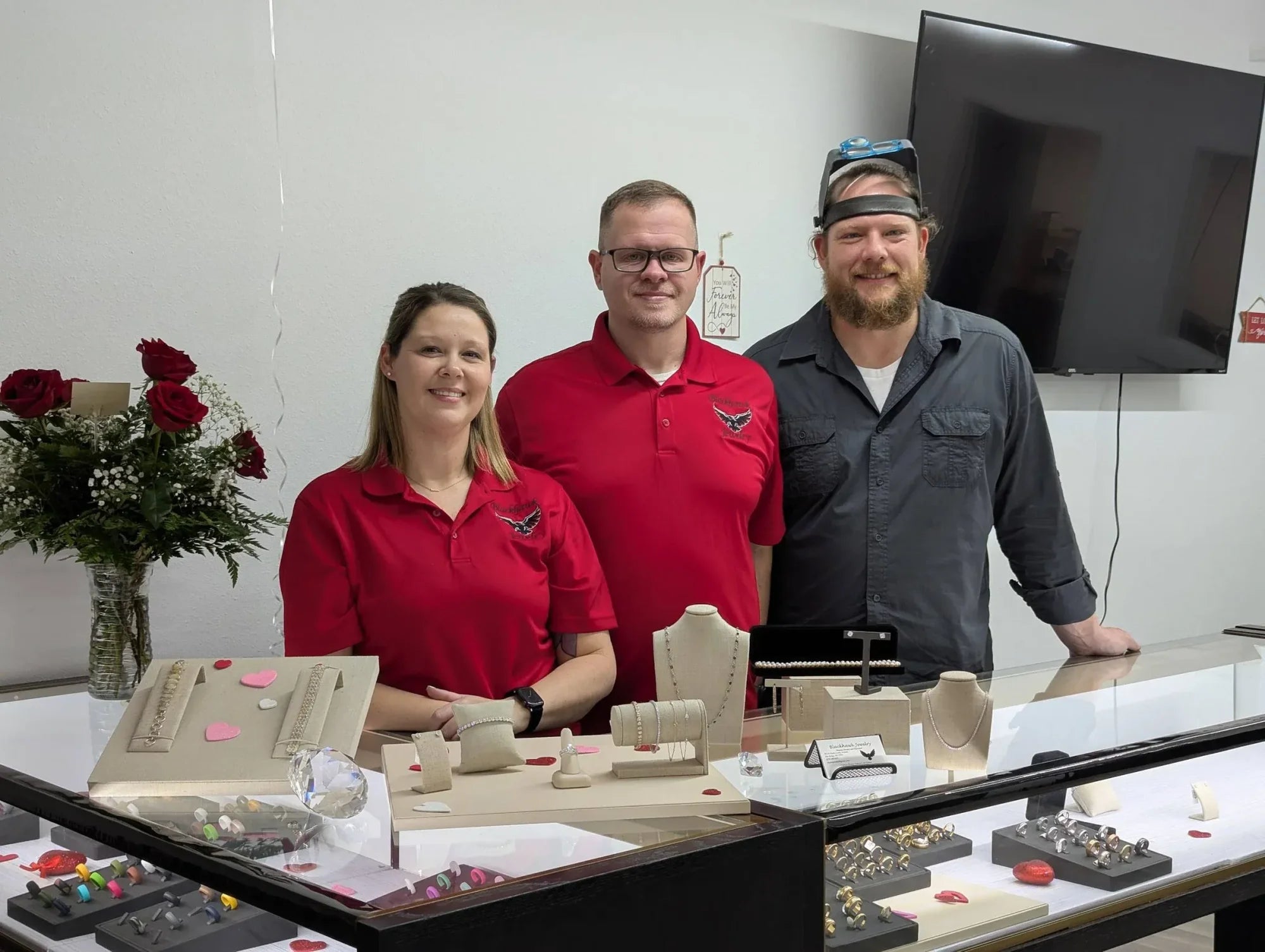 Owners Gloria Black, Rick Black and Joseph Suchy at the Blackhawk Jewelry counter